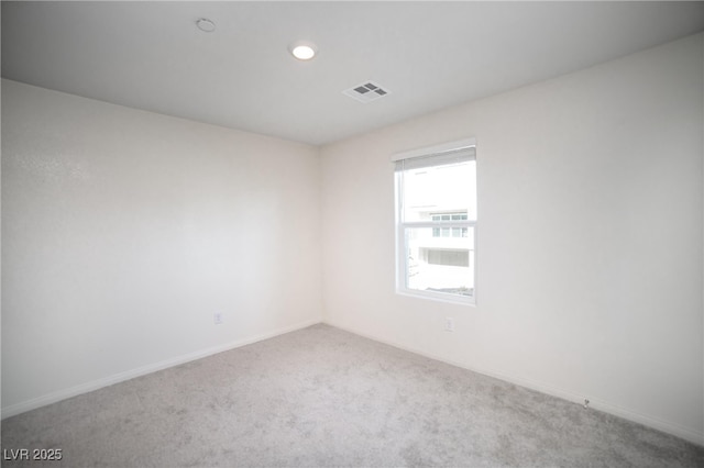 spare room with visible vents, recessed lighting, baseboards, and carpet floors