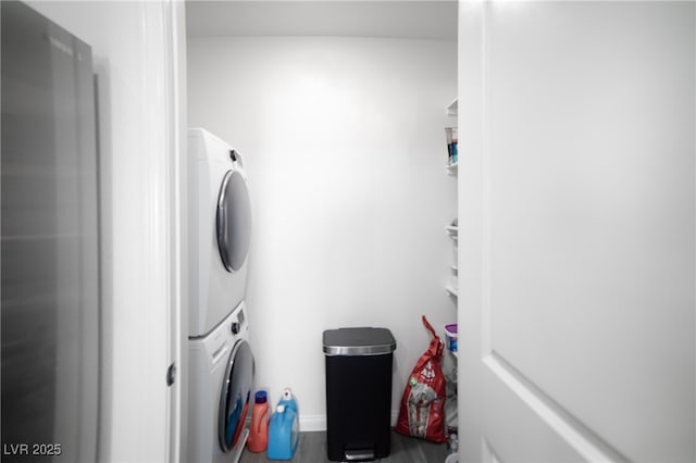 laundry room featuring laundry area and stacked washer / drying machine