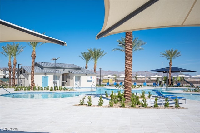 pool featuring fence and a patio area