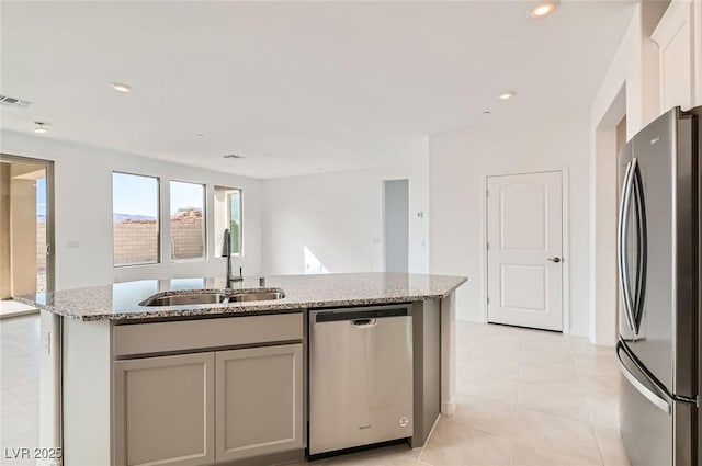 58 Sun Lily Ln, Henderson, NV 89011 - kitchen with light stone counters, stainless steel appliances, visible vents, and a sink