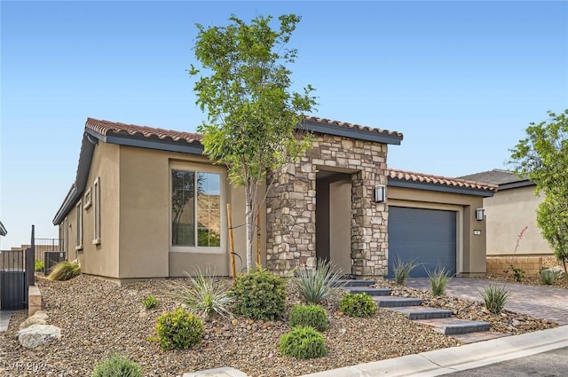 58 Sun Lily Ln, Henderson, NV 89011 - mediterranean / spanish-style home featuring an attached garage, stucco siding, and a tiled roof