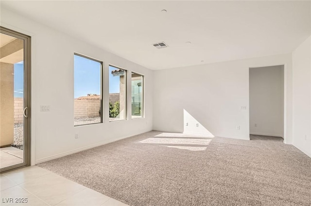 58 Sun Lily Ln, Henderson, NV 89011 - unfurnished room featuring light carpet, baseboards, light tile patterned floors, and visible vents