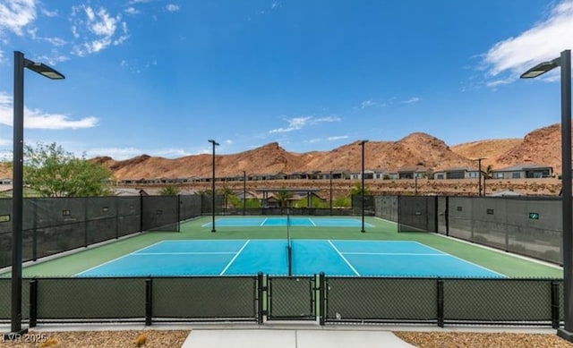 58 Sun Lily Ln, Henderson, NV 89011 - view of sport court with a gate, fence, and a mountain view