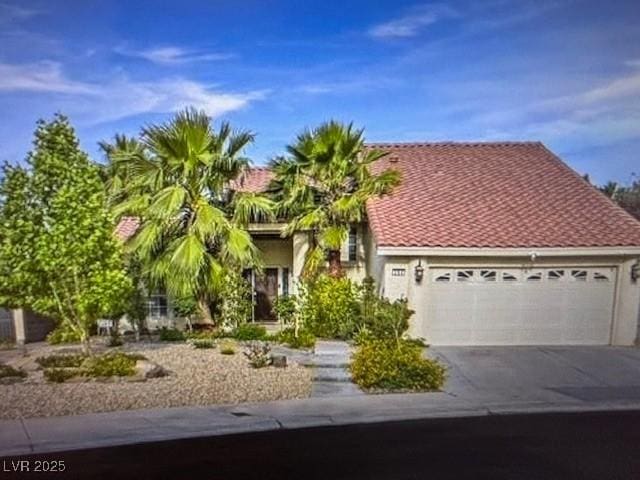 390 Rushing Creek Ct, Henderson, NV 89014 - view of front facade featuring an attached garage, asphalt driveway, a tiled roof, and stucco siding