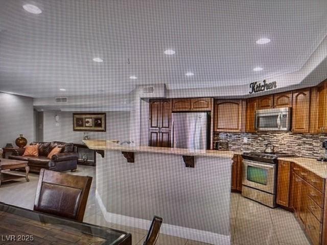 390 Rushing Creek Ct, Henderson, NV 89014 - kitchen featuring stainless steel appliances, a kitchen breakfast bar, and light countertops