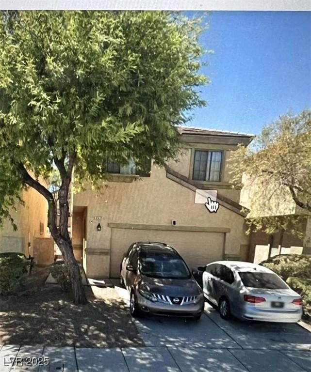 6531 Goldfield St, North Las Vegas, NV 89084 - view of front facade with a garage, stucco siding, and concrete driveway