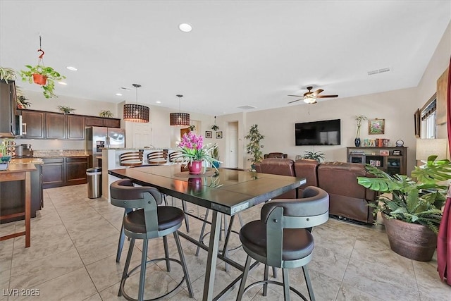 5226 Lignum Ave Unit 1, Pahrump, NV 89061 - kitchen featuring dark brown cabinets, ceiling fan, stainless steel fridge with ice dispenser, light countertops, and pendant lighting