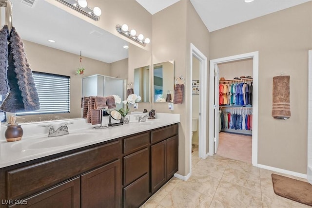 5226 Lignum Ave Unit 1, Pahrump, NV 89061 - bathroom with double vanity, tile patterned flooring, a stall shower, a sink, and toilet