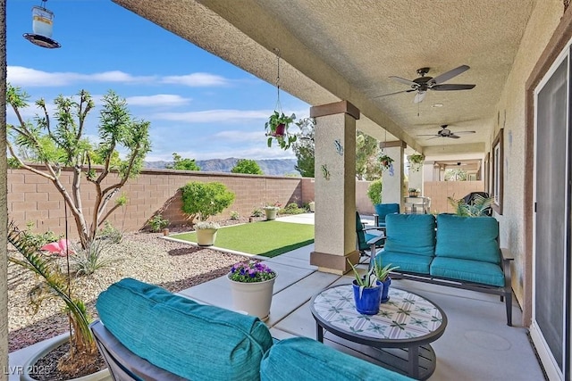 5226 Lignum Ave Unit 1, Pahrump, NV 89061 - view of patio with an outdoor living space, a ceiling fan, and a fenced backyard
