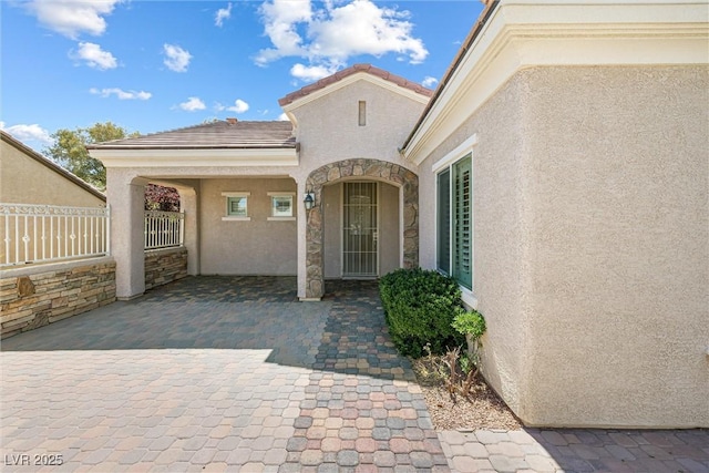 2164 Sawtooth Mountain Dr, Henderson, NV 89044 - property entrance featuring fence, stucco siding, and a tiled roof