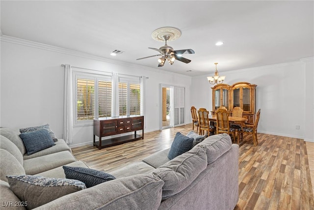 2164 Sawtooth Mountain Dr, Henderson, NV 89044 - living area with visible vents, ornamental molding, light wood-style flooring, and ceiling fan with notable chandelier