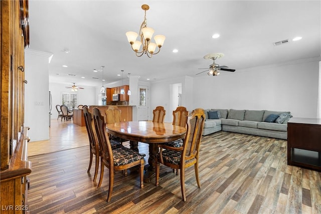 2164 Sawtooth Mountain Dr, Henderson, NV 89044 - dining space with ceiling fan with notable chandelier, recessed lighting, wood finished floors, and visible vents