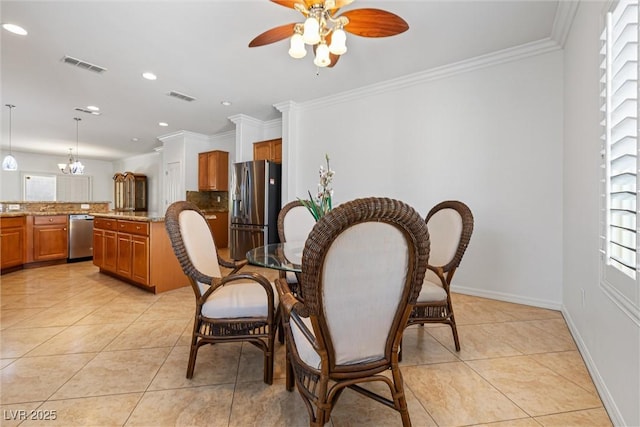 2164 Sawtooth Mountain Dr, Henderson, NV 89044 - dining area with crown molding, light tile patterned flooring, ceiling fan, and visible vents