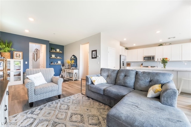 23 Strada Barbera, Henderson, NV 89011 - living room featuring light wood finished floors and recessed lighting