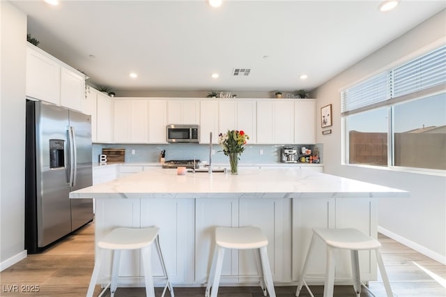 23 Strada Barbera, Henderson, NV 89011 - kitchen featuring stainless steel appliances, light wood-style floors, backsplash, baseboards, and recessed lighting