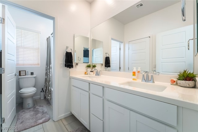 23 Strada Barbera, Henderson, NV 89011 - full bathroom with double vanity, toilet, and baseboards