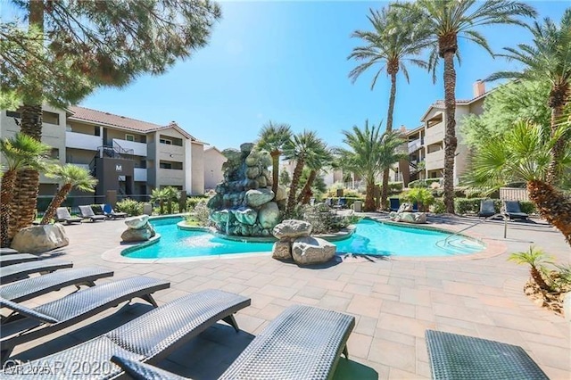 pool with a patio and a residential view