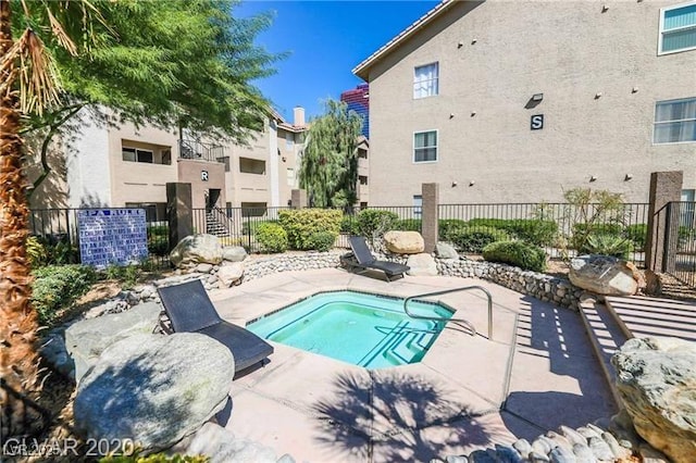 view of pool featuring a patio and fence