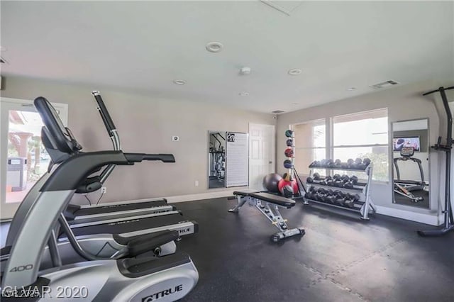 exercise room featuring baseboards and visible vents