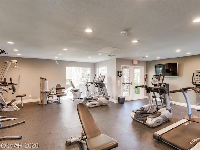gym featuring recessed lighting, baseboards, and a wealth of natural light