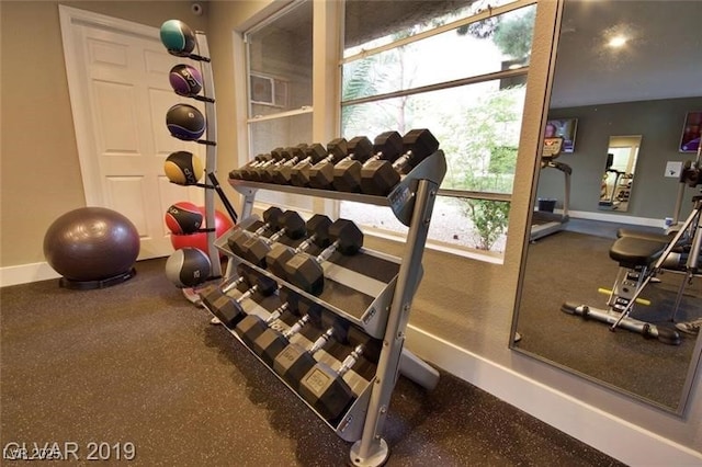 gym featuring baseboards