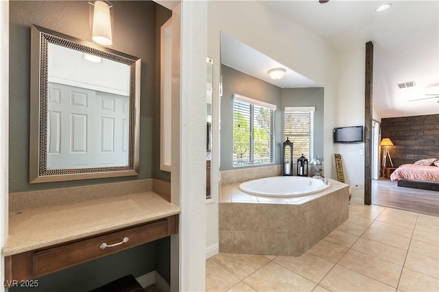 ensuite bathroom with tile patterned flooring, ensuite bathroom, a bath, and visible vents