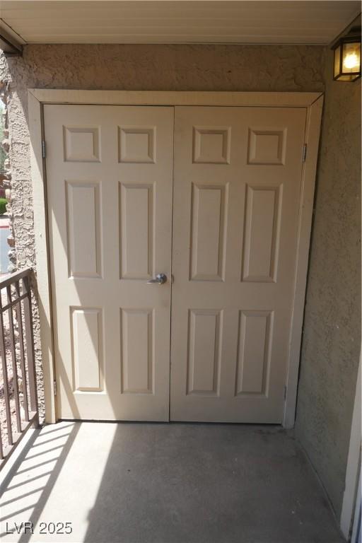 entrance to property featuring stucco siding