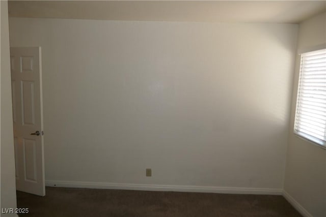 spare room with carpet floors and baseboards