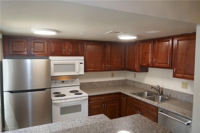 kitchen featuring visible vents, a sink, and stainless steel appliances