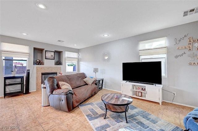 722 Chepstow Ave, Las Vegas, NV 89178 - living room with visible vents, recessed lighting, a glass covered fireplace, and light tile patterned floors