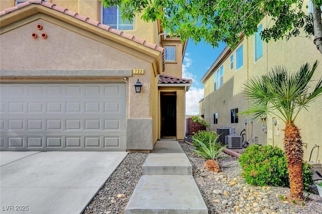 722 Chepstow Ave, Las Vegas, NV 89178 - view of front of property featuring a garage, cooling unit, stucco siding, a tiled roof, and concrete driveway