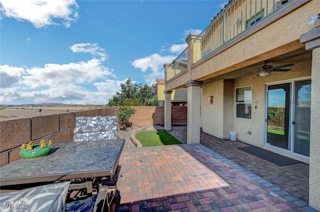 722 Chepstow Ave, Las Vegas, NV 89178 - view of patio with outdoor dining area, a fenced backyard, ceiling fan, and a balcony