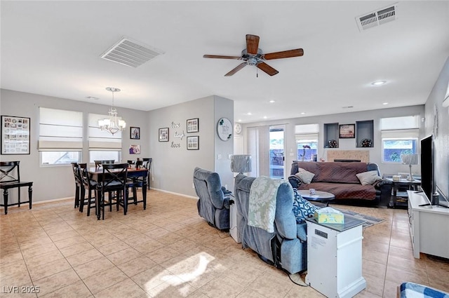 722 Chepstow Ave, Las Vegas, NV 89178 - living room featuring visible vents, ceiling fan with notable chandelier, and light tile patterned floors