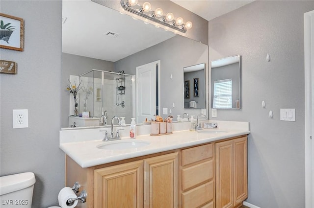 722 Chepstow Ave, Las Vegas, NV 89178 - bathroom featuring visible vents, a sink, a stall shower, and toilet