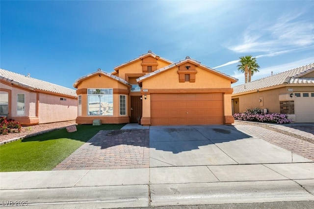 view of front of property featuring a garage, stucco siding, a tiled roof, and concrete driveway