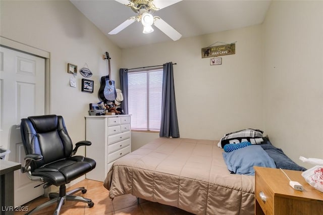 tiled bedroom featuring a ceiling fan