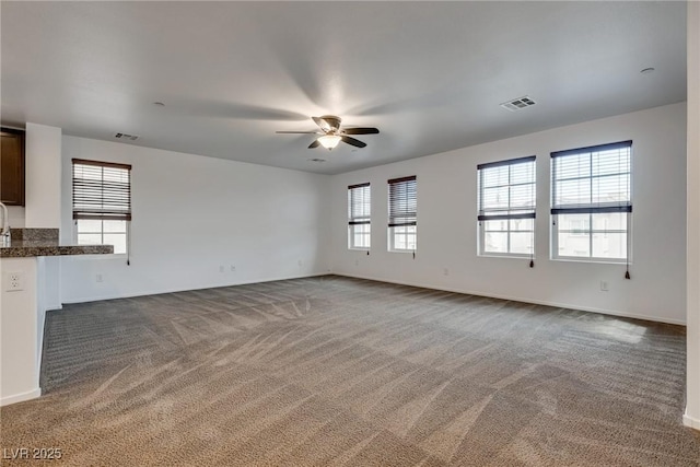 345 Gracious Way, Henderson, NV 89011 - unfurnished living room with ceiling fan, carpet floors, and baseboards