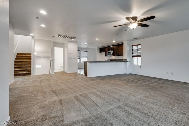 345 Gracious Way, Henderson, NV 89011 - unfurnished living room featuring a ceiling fan, carpet floors, stairway, recessed lighting, and baseboards