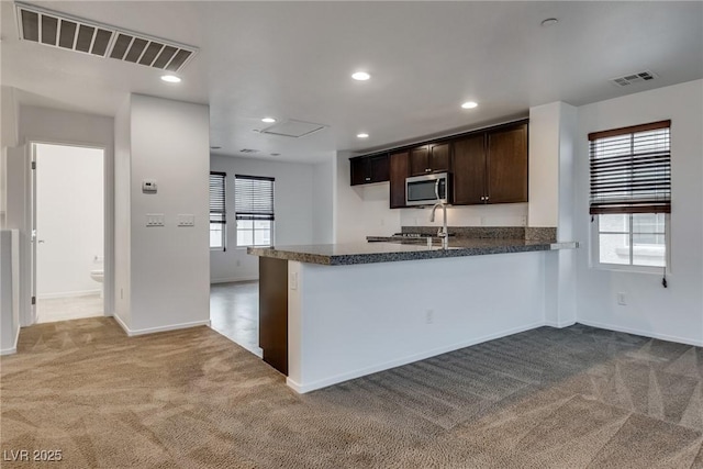 345 Gracious Way, Henderson, NV 89011 - kitchen with stainless steel microwave, carpet floors, dark brown cabinetry, baseboards, and recessed lighting
