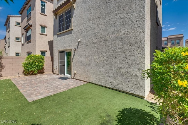345 Gracious Way, Henderson, NV 89011 - rear view of house featuring fence, a patio, and stucco siding