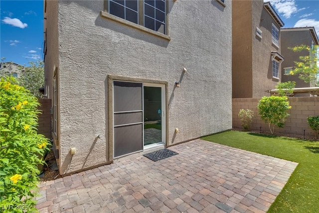 345 Gracious Way, Henderson, NV 89011 - back of property with stucco siding, fence, and a patio