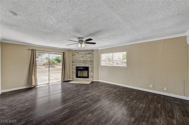 unfurnished living room featuring ceiling fan, a textured ceiling, a stone fireplace, wood finished floors, and baseboards