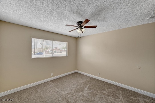 unfurnished room featuring baseboards, a ceiling fan, a textured ceiling, and carpet flooring