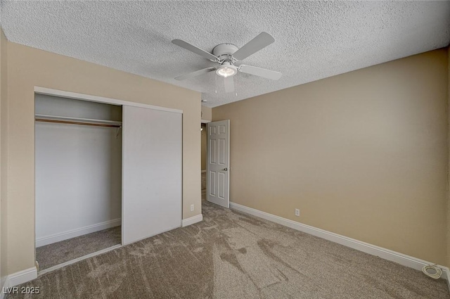 unfurnished bedroom with carpet floors, baseboards, a closet, and a textured ceiling