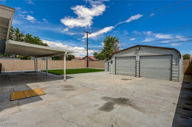 detached garage featuring fence