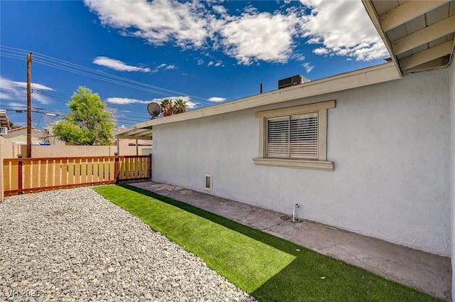 view of home's exterior featuring fence, a patio, and stucco siding