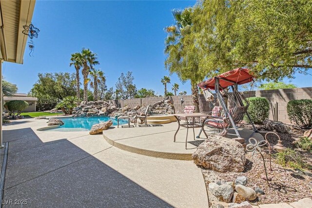 view of swimming pool featuring a fenced in pool, a fenced backyard, and a patio area