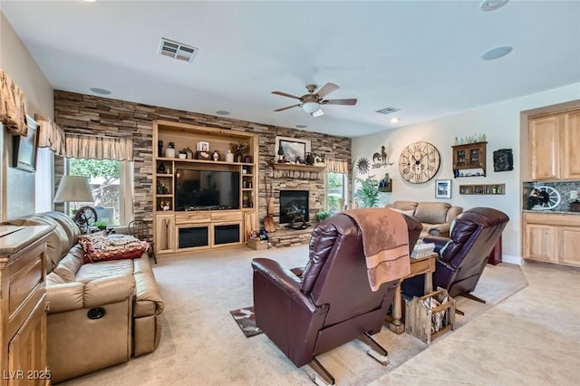 living room with ceiling fan, a fireplace, recessed lighting, and visible vents