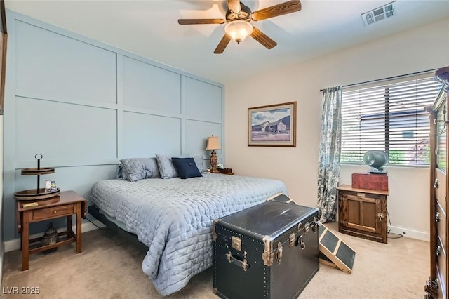 bedroom with baseboards, visible vents, ceiling fan, and light colored carpet