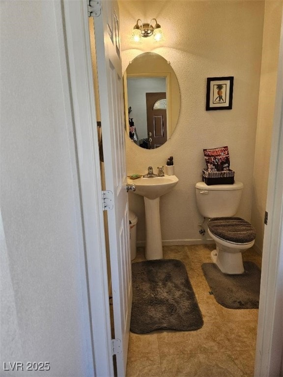 half bathroom with a sink and toilet